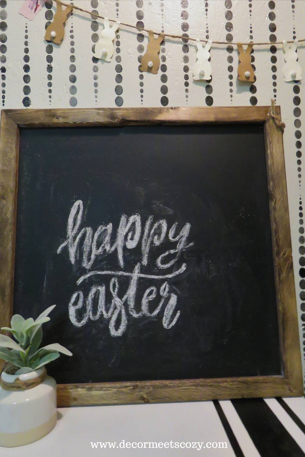 A wooden sign board with happy easter on it.